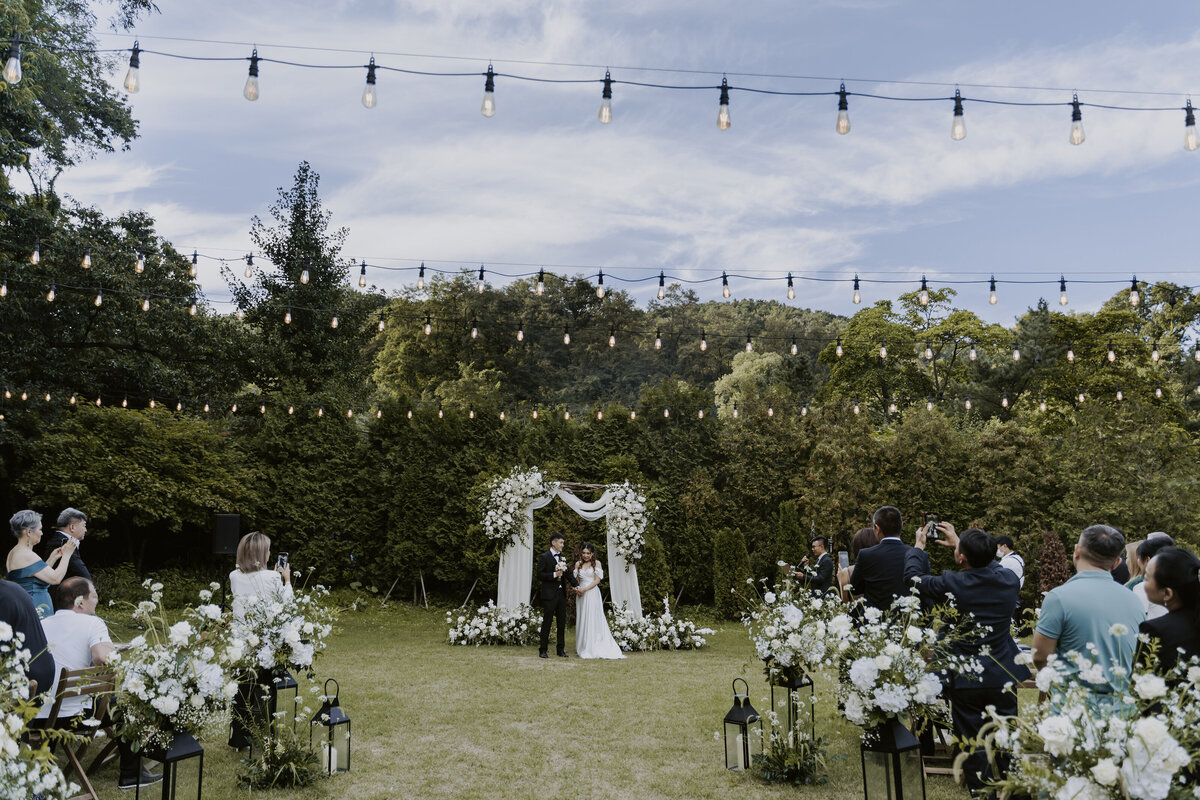 the couple standing in front of  their guests