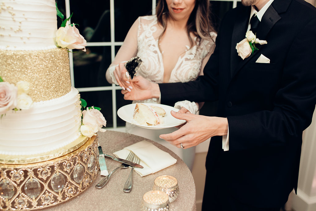 Wedding Photograph Of Bride And Groom Taking A Slice Of The Wedding Cake Los Angeles