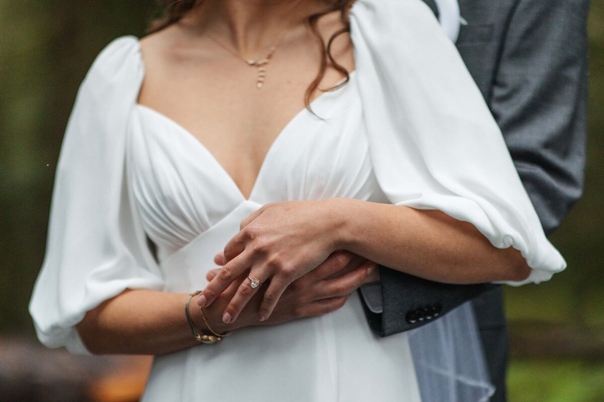 close up photo of a bride and grooms hands and their wedding rings at Victorian Vineyards in Brush Prarie Washington