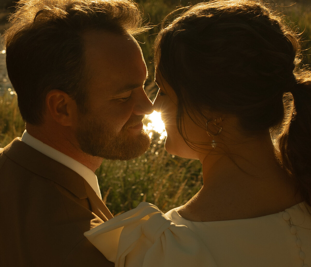 Bride and groom snuggling at their Rocky Mountain National Park elopement during golden hour.
