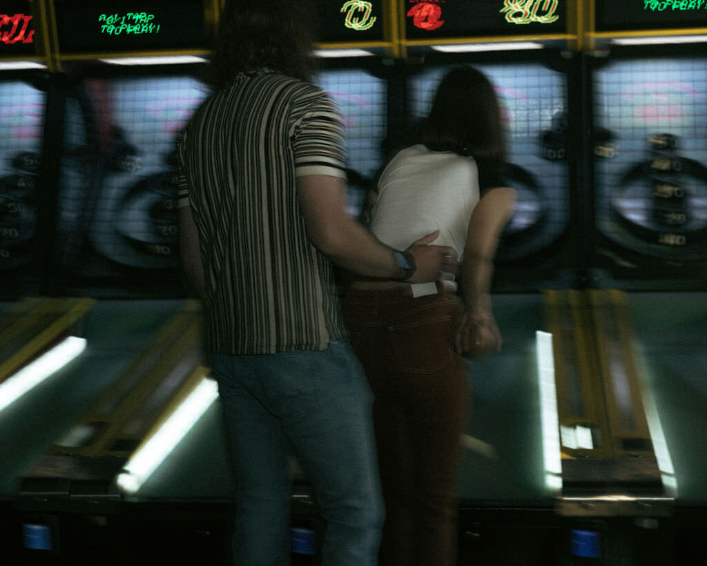 Two people playing ski ball together.