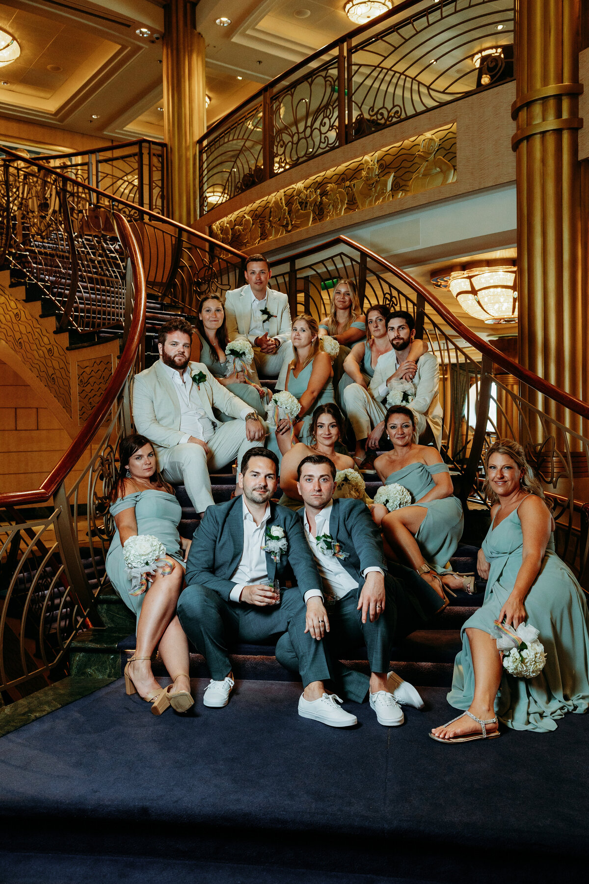 Wedding party sitting on the stairs on the Disney Fantasy