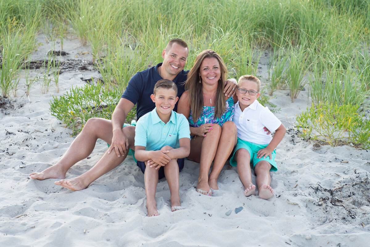 Family portrait of four in the dunegrass on Oguquit Beach Maine