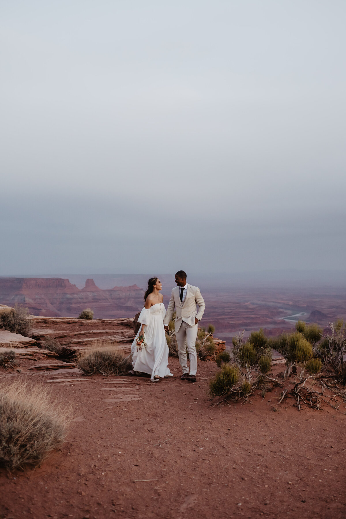 Utah Elopement Photographer capture bride and groom walking holding hands