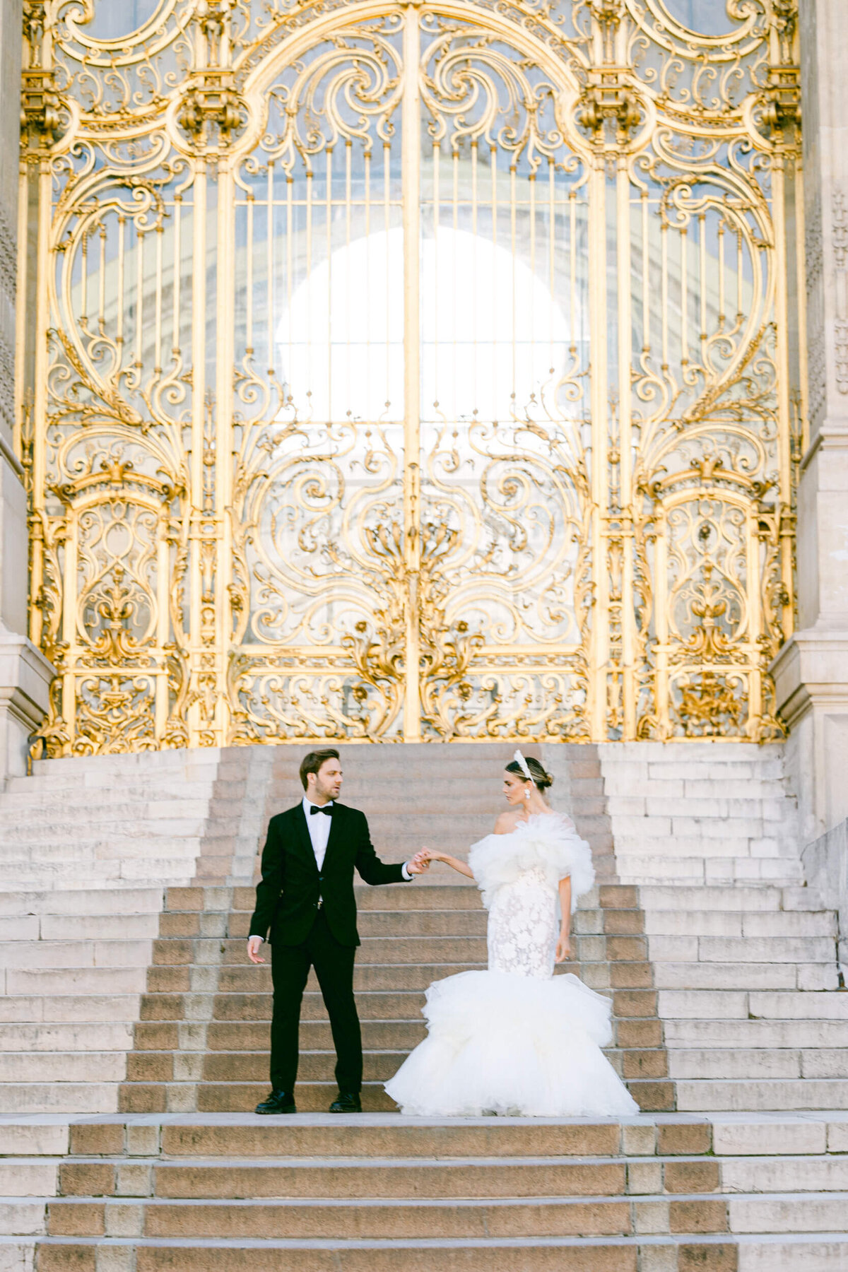 A wedding photo of a bride in her white dress in the streets of Paris in France.