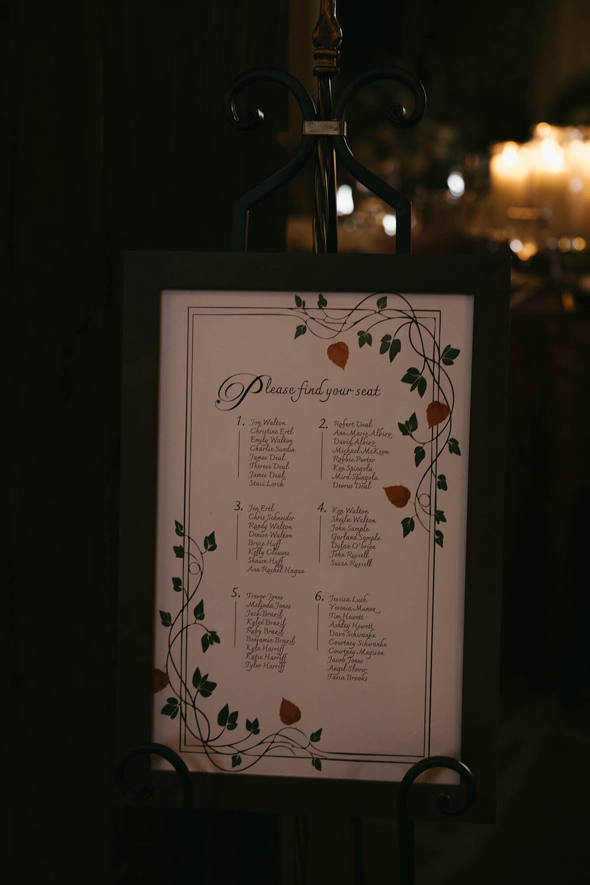 A decorative table seating chart at a fall wedding held at the Chateau De Lis.