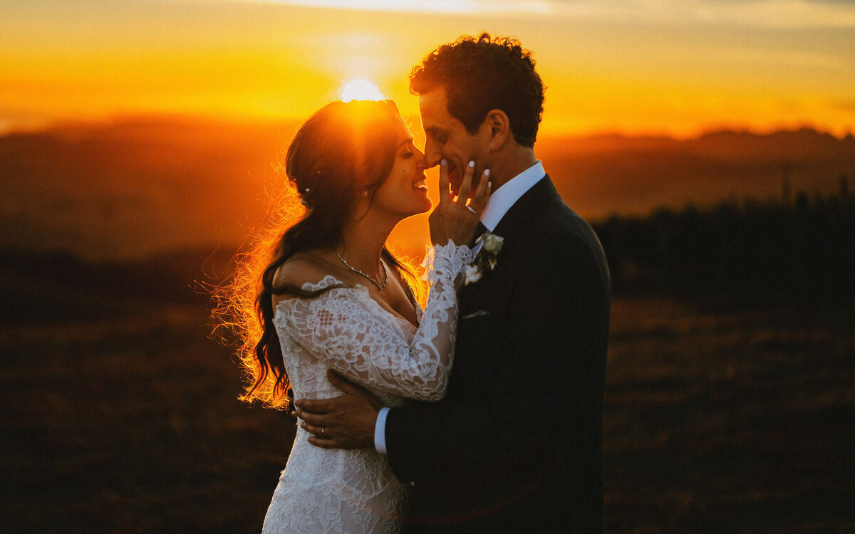 Bride and groom embrace during golden hour at Albatross Ridge Winery in Carmel Valley, reflecting the same cinematic style we bring to Asheville weddings in the Blue Ridge Mountains.