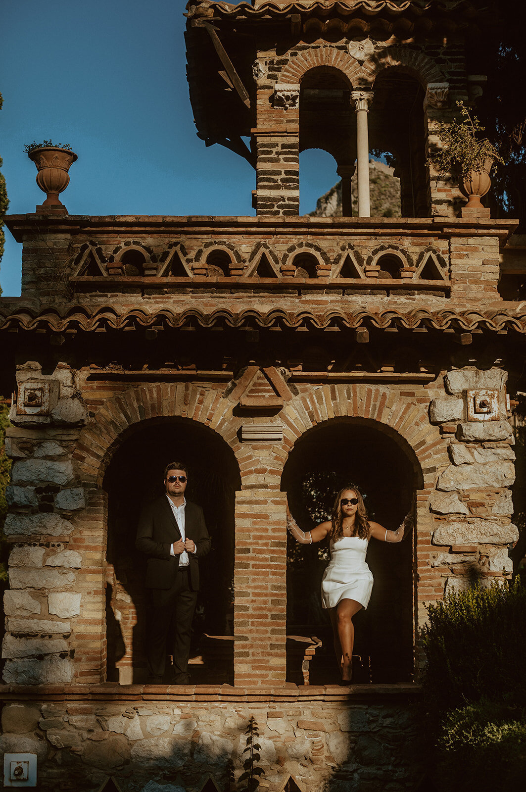 editorial engagement photos in taormina with woman in white dress and man in suit