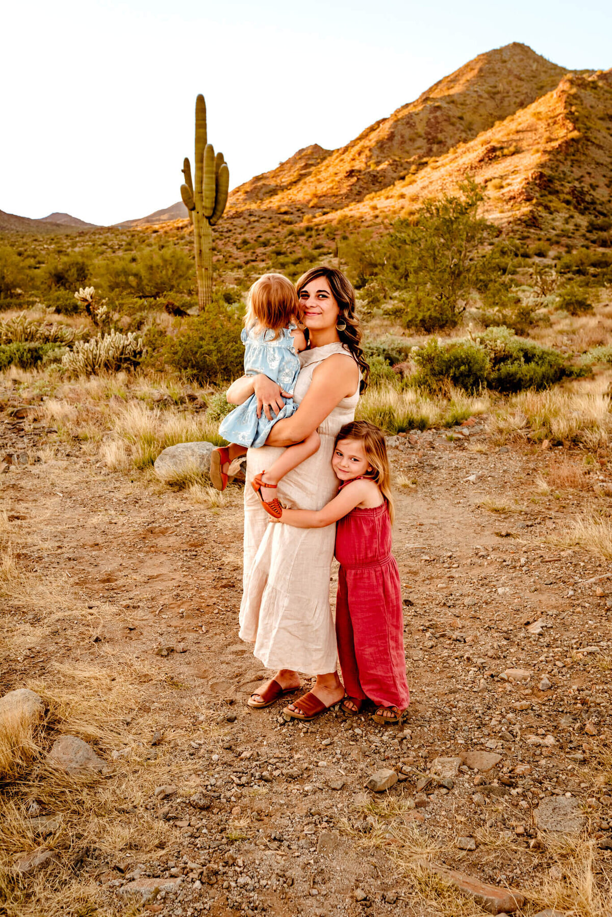 AZ mom hugging daughters for photography