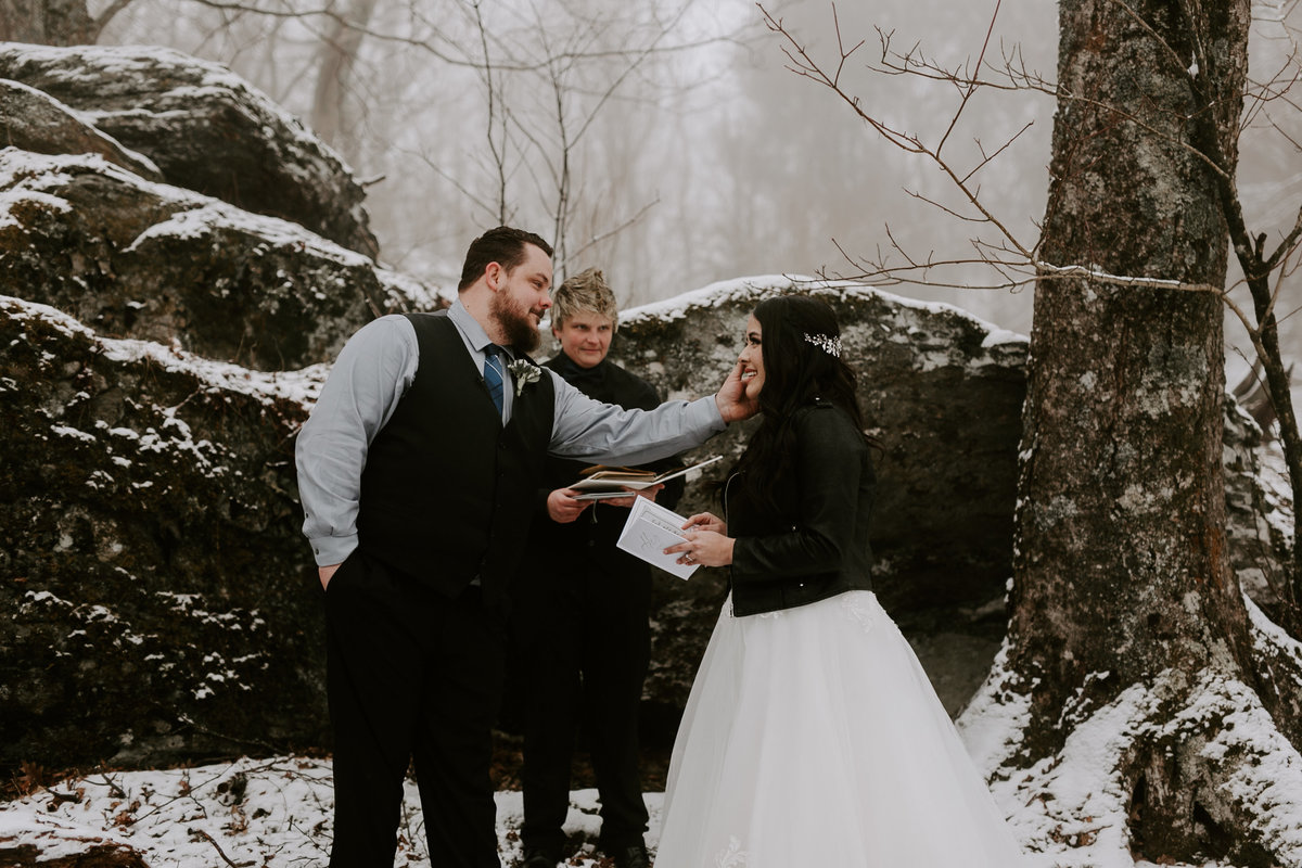 Couple saying their vows in the snow during their elopement in Boone NC