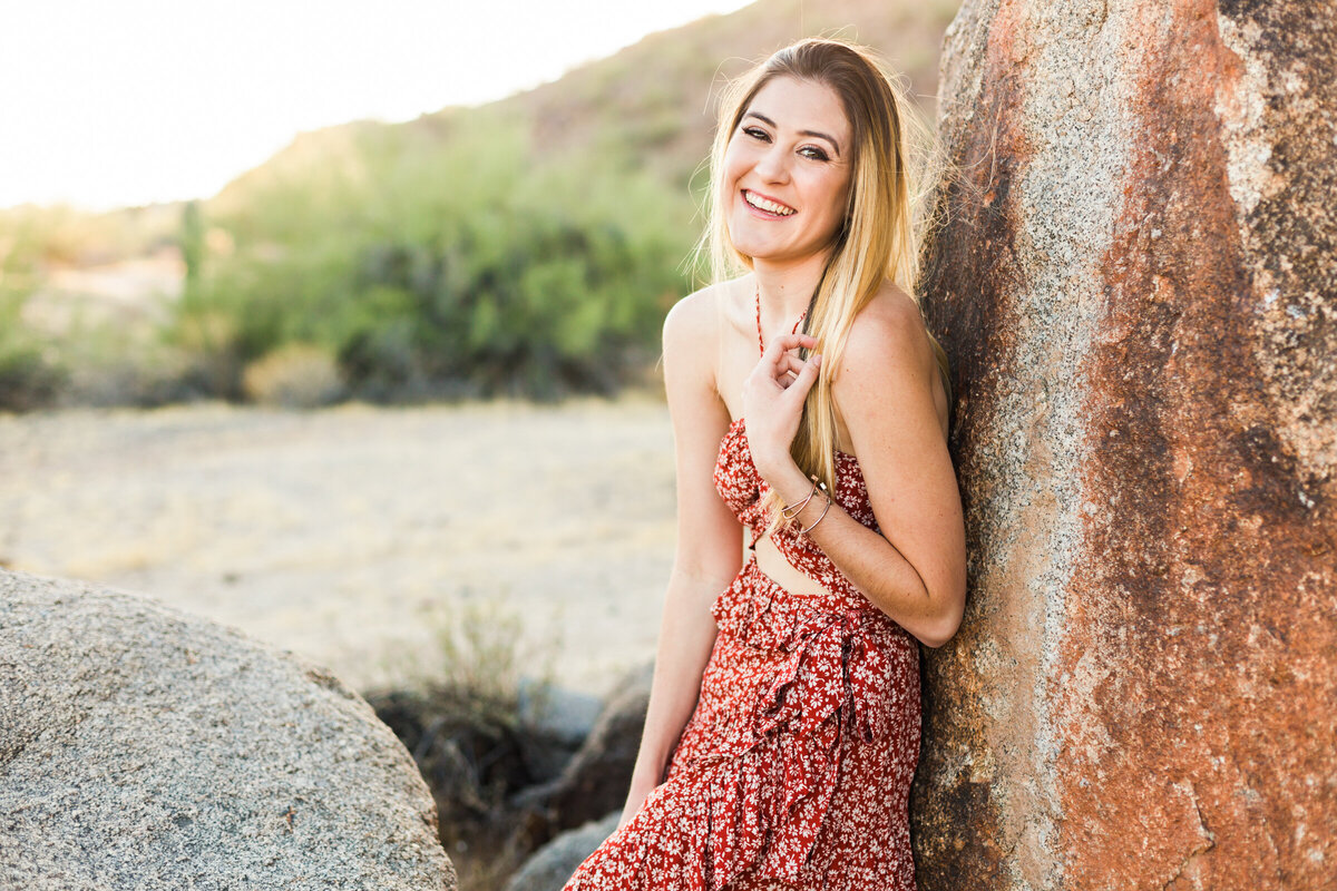 college senior girl leaning on rock in the Phoenix desert