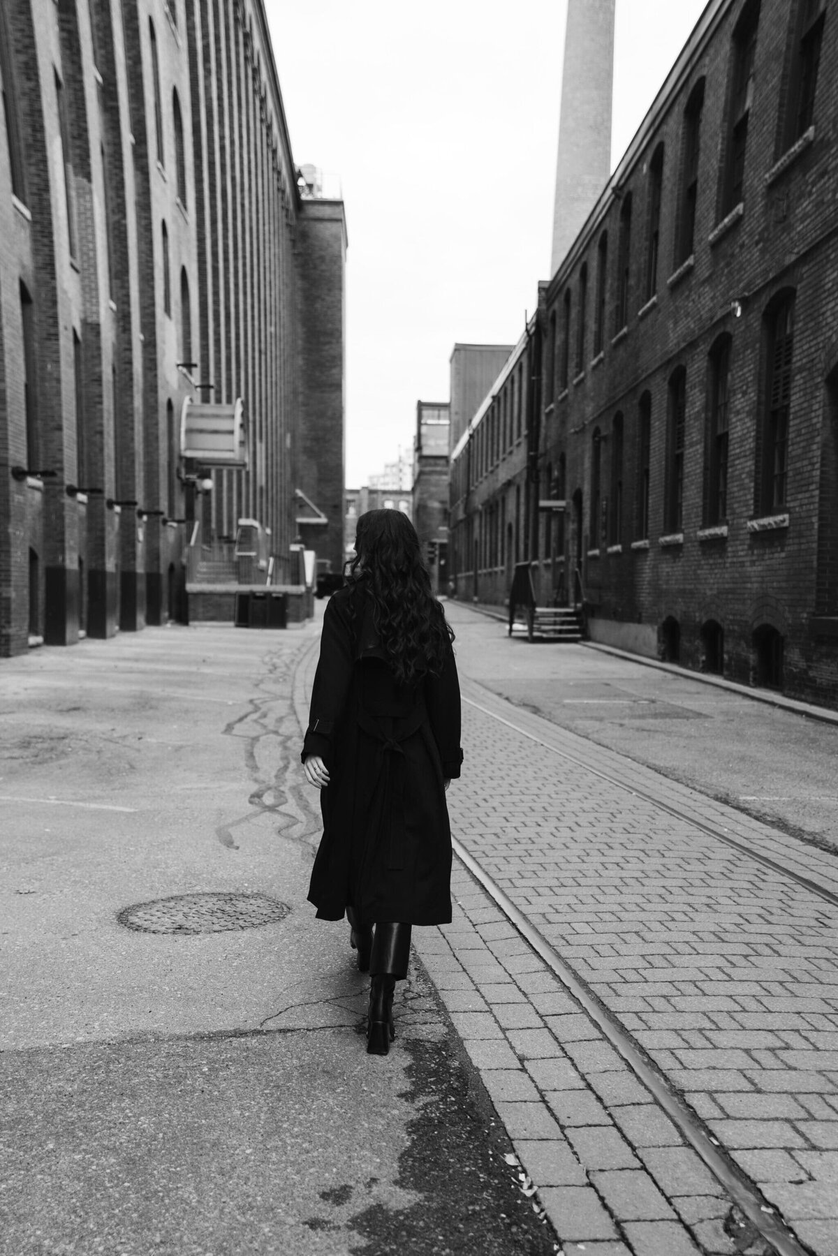 Black and white photo of creative entrepreneur walking down the street