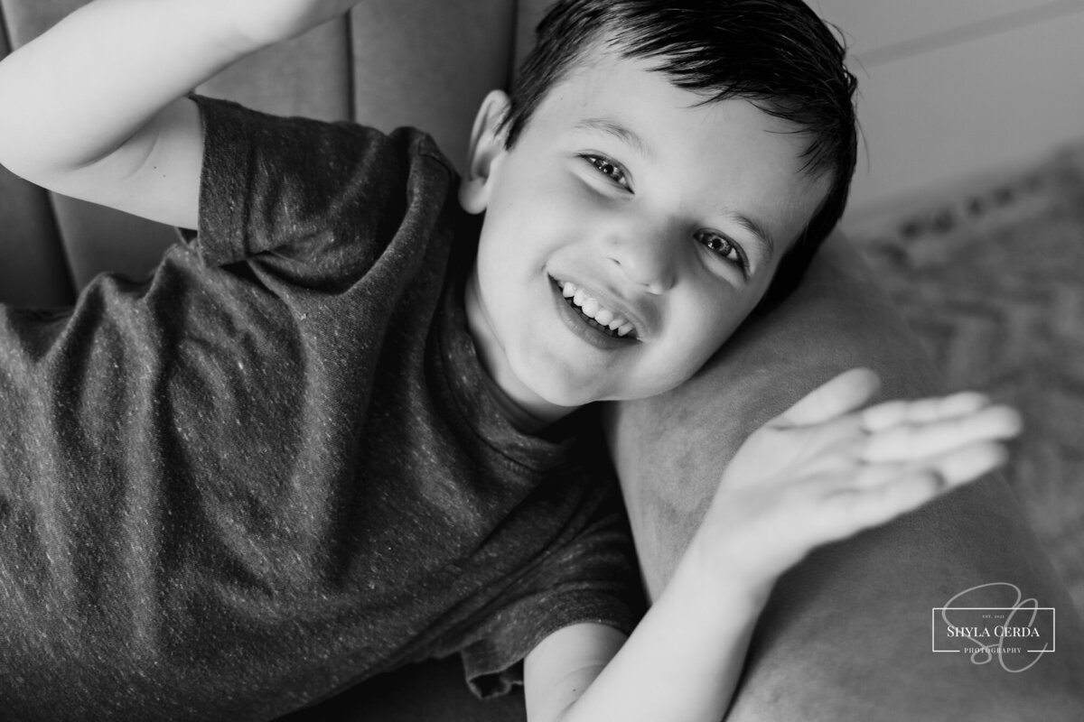 Boy playing peek-a-boo with camera