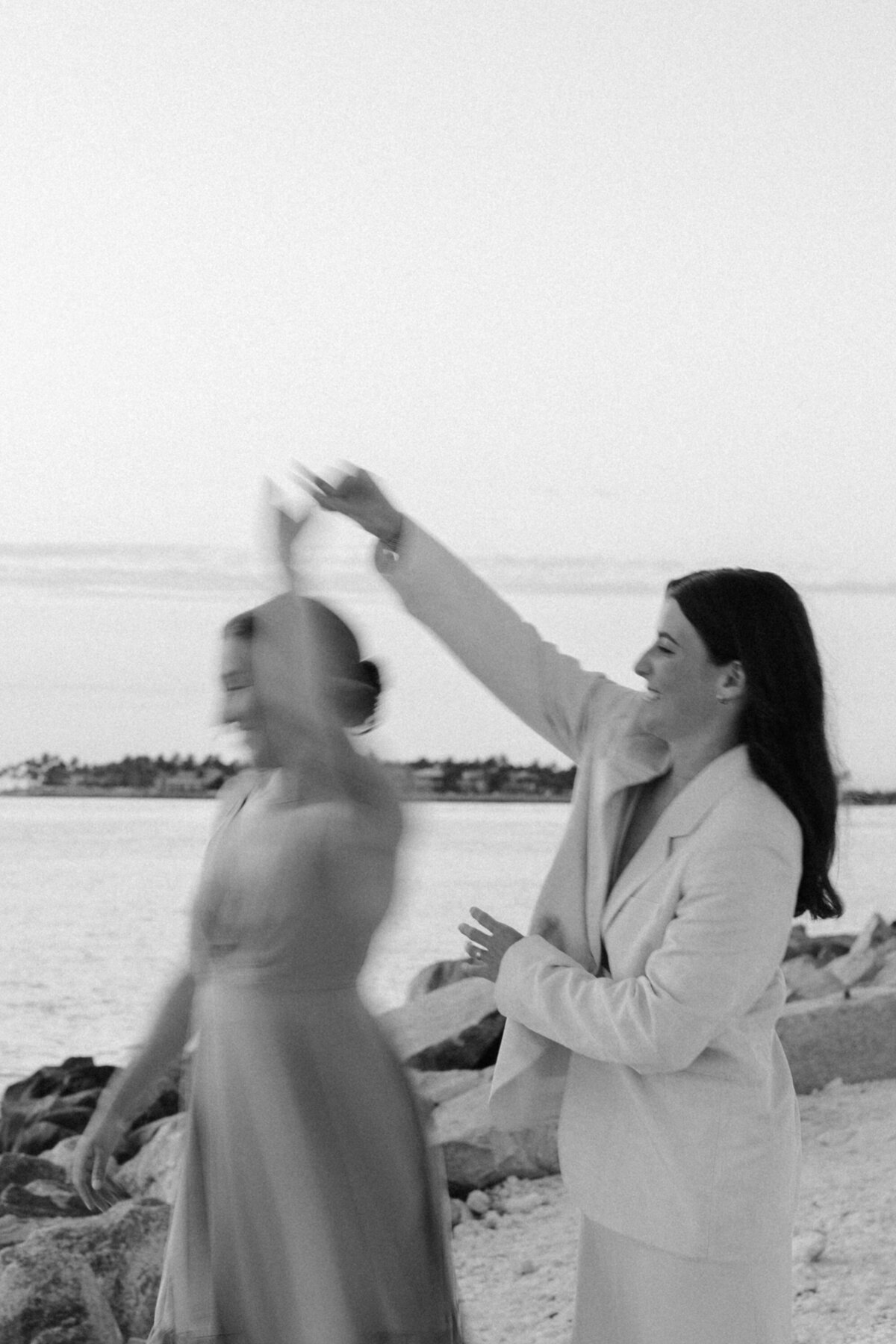 Women Dancing by the Beach during Elopement