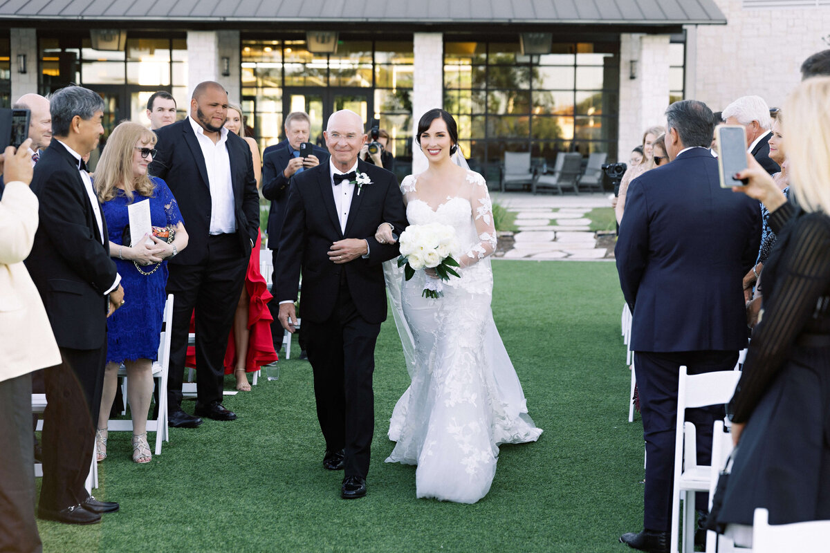 bride walking down aisle at Omni Barton Creek