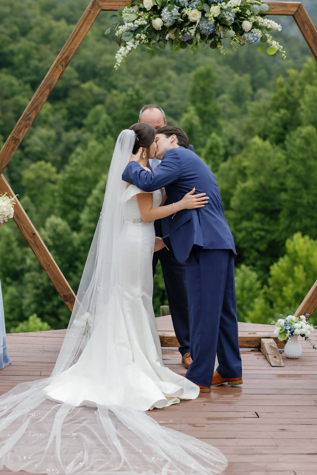 passionate kiss between bride at groom at the end of their outdoor wedding ceremony at Mountain Mist 