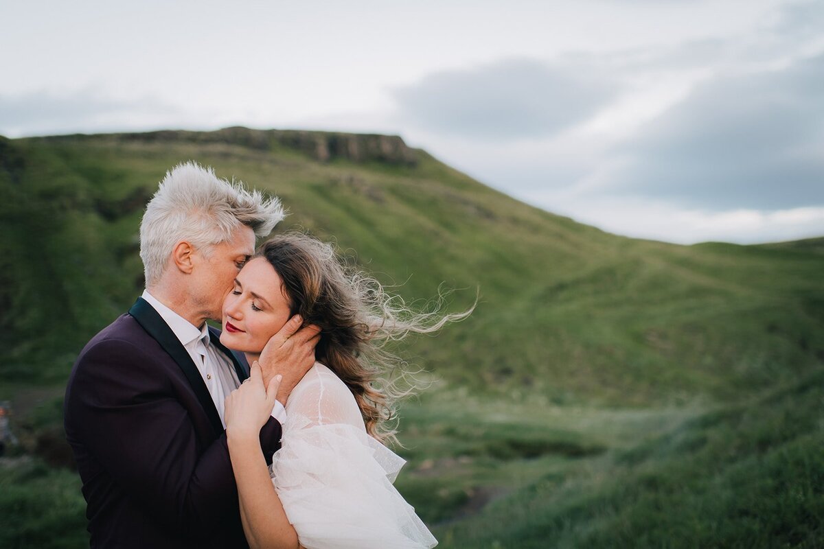 Portrait of a couple embracing in a mountainous landscape
