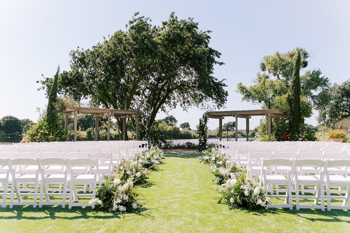 ceremony at willow ballroom with meadow flowers floor installations and pillar flowers