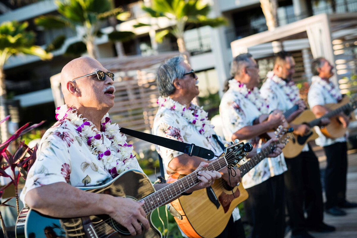Hawaiian Singers with guitars performs at the Mauna Lani Resort for a destination corporate event