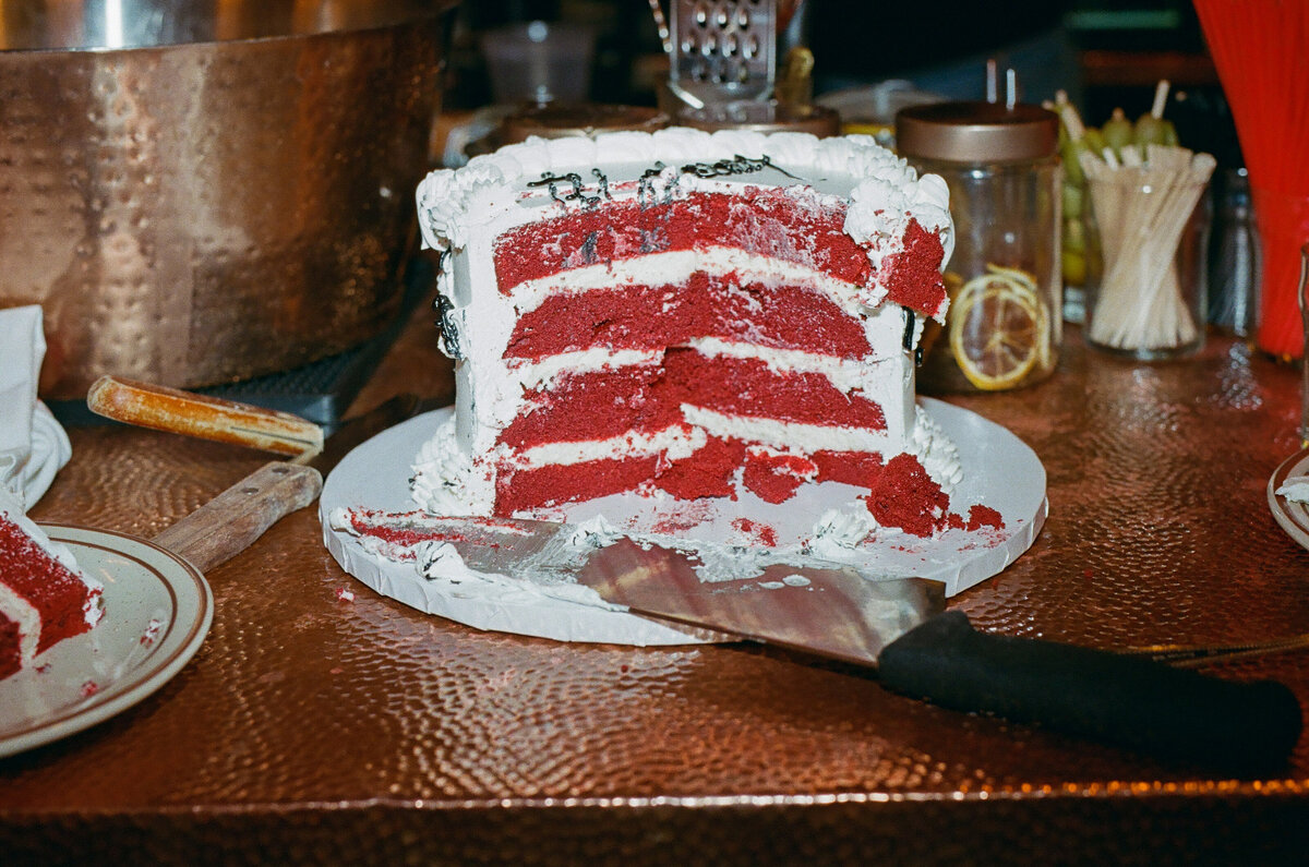 A half cut up red velvet cake.