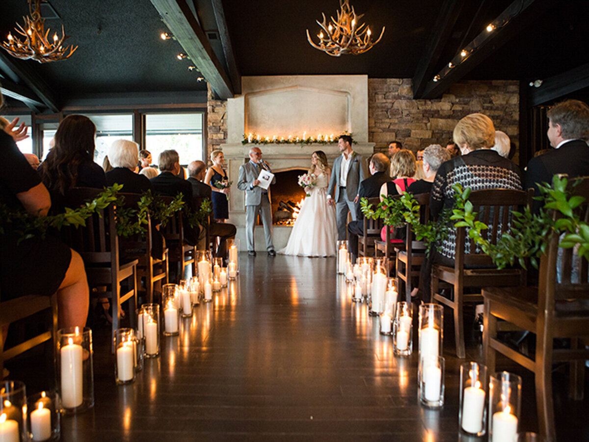 Beautiful candle lit wedding ceremony at The Lakehouse, a romantic sophisticated wedding venue in Calgary, featured on the Brontë Bride Vendor Guide.
