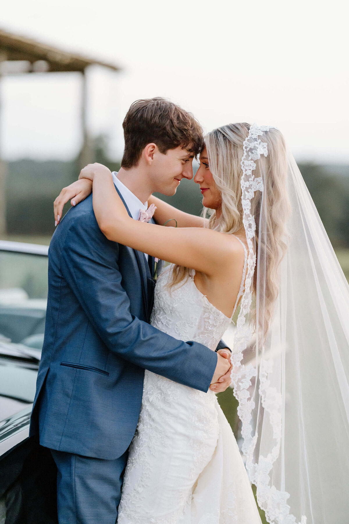 intimate portrait of groom hugging bride on wedding day