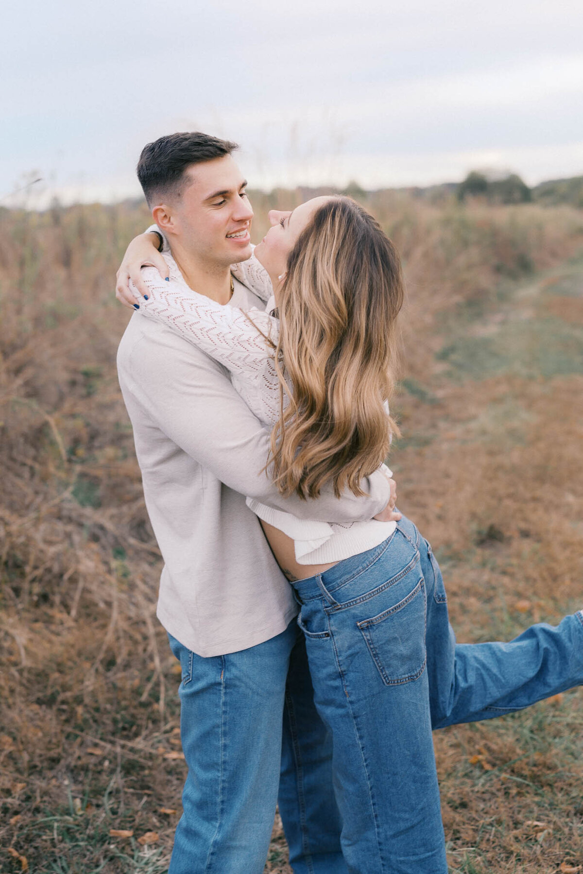 man and woman hug at seven islands state birding park in october near knoxville tennessee