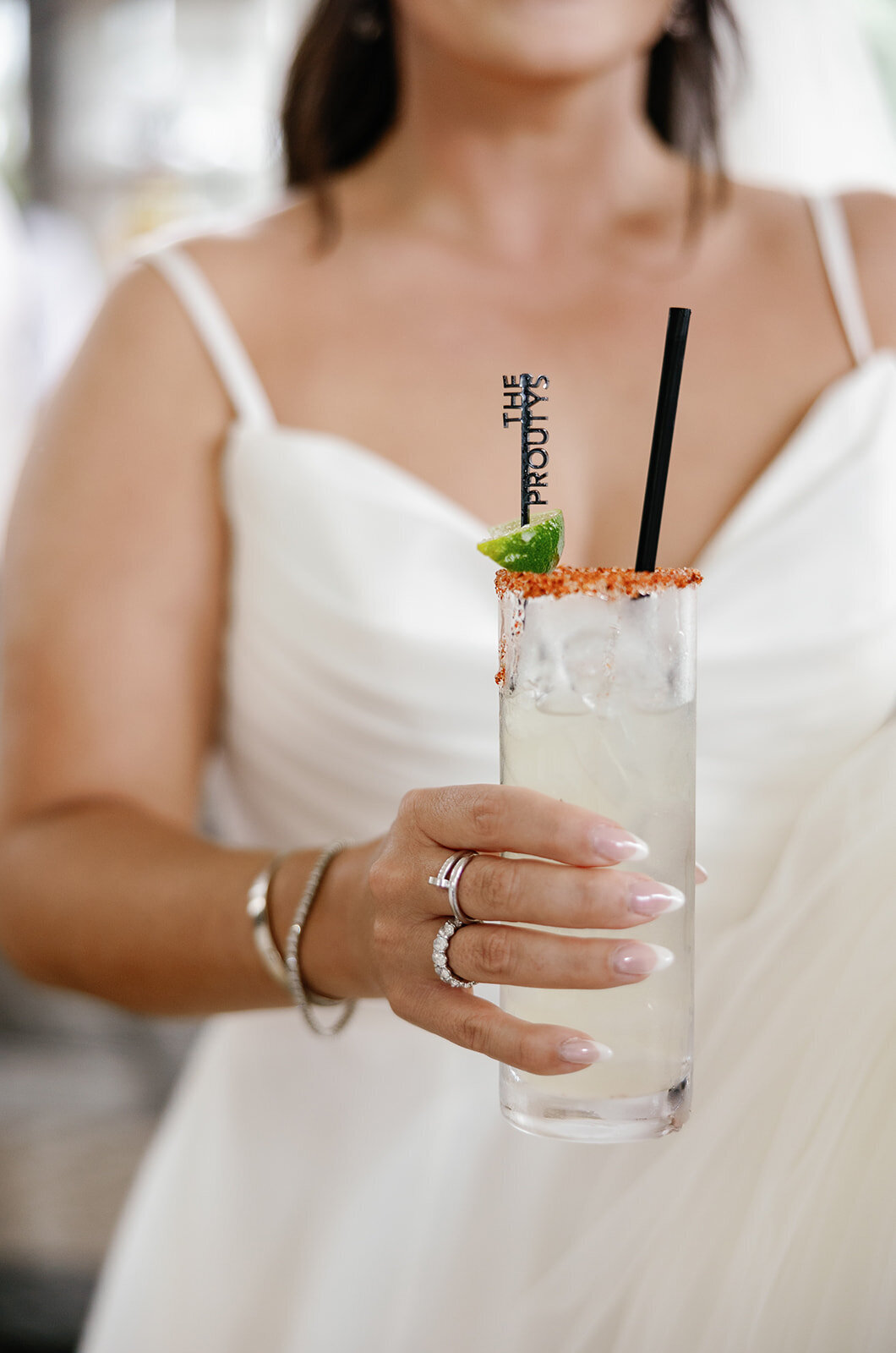 Close-up of the bride’s signature cocktail with a custom stirrer, beautifully detailed at Ashley and Cameron's micro wedding at Ocean Reef in Key Largo, captured by Claudia Amalia Photography.