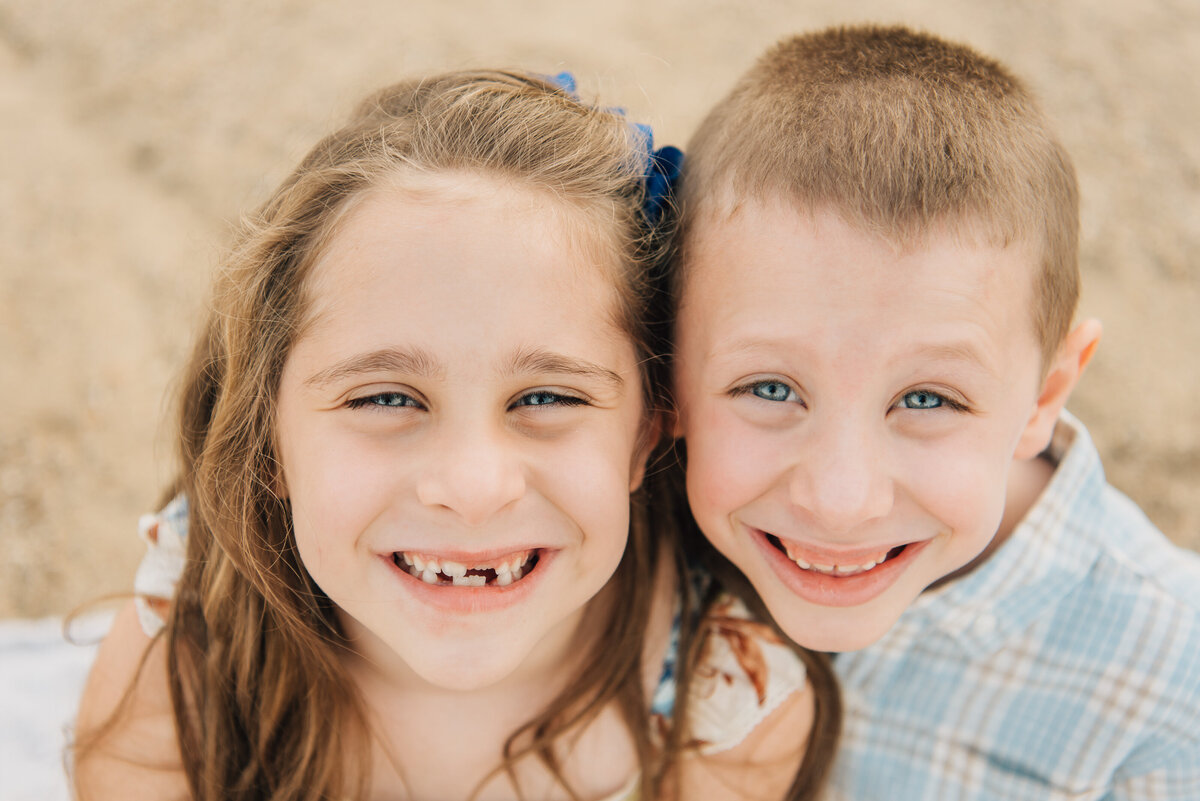 Close up of brother and sister on the beach