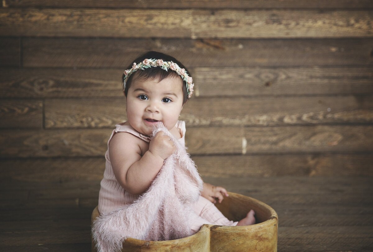 Toddler girl with wood background and flower crown