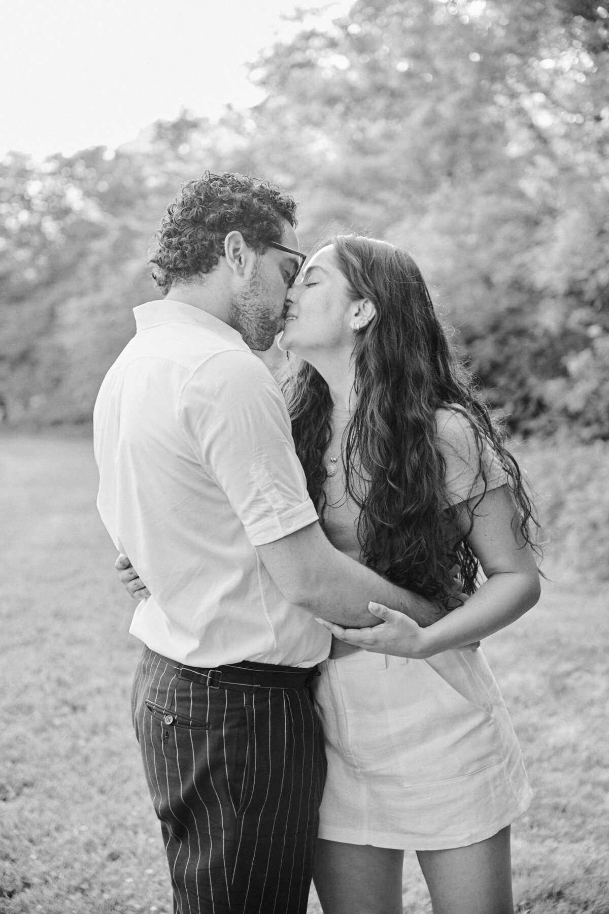 Couple stand face to face smiling after a successful New York City Picnic Proposal.  Photo taken by NYC Proposal Photographer, Corey Lamar Photography