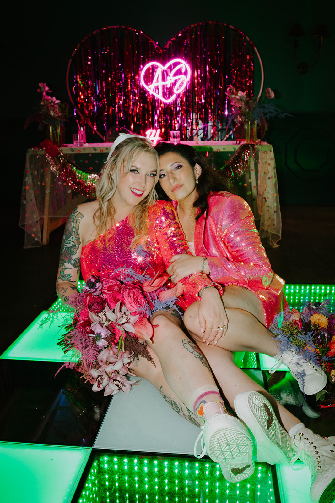 queer wedding couple in pink sequin outfits at the Fig House in Los Angeles 