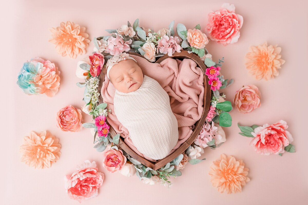 newborn surrounded by florals
