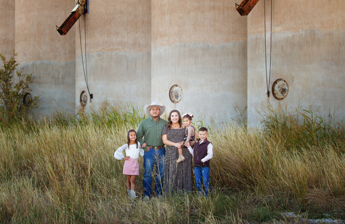 Family standing next to silos in Canyon tx