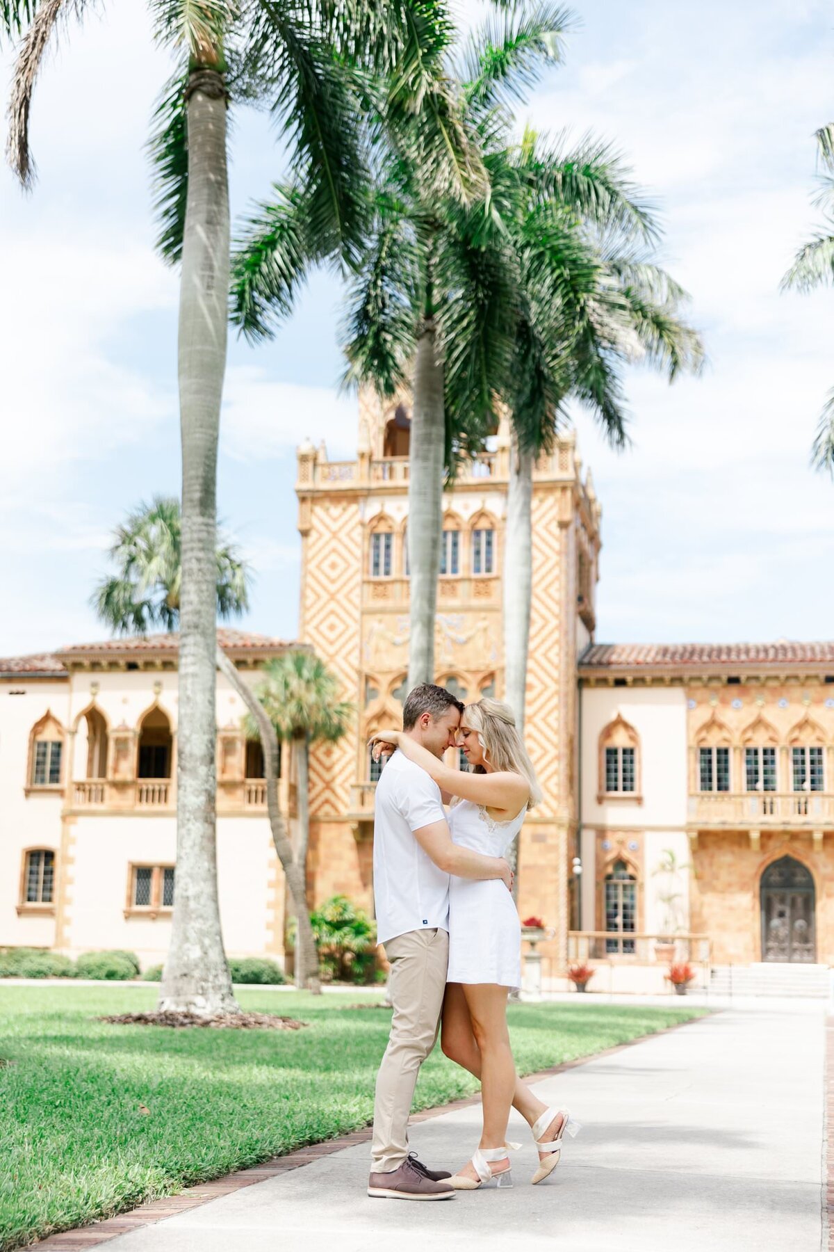 couple smiling and holding each other by wedding photographer in sarasota