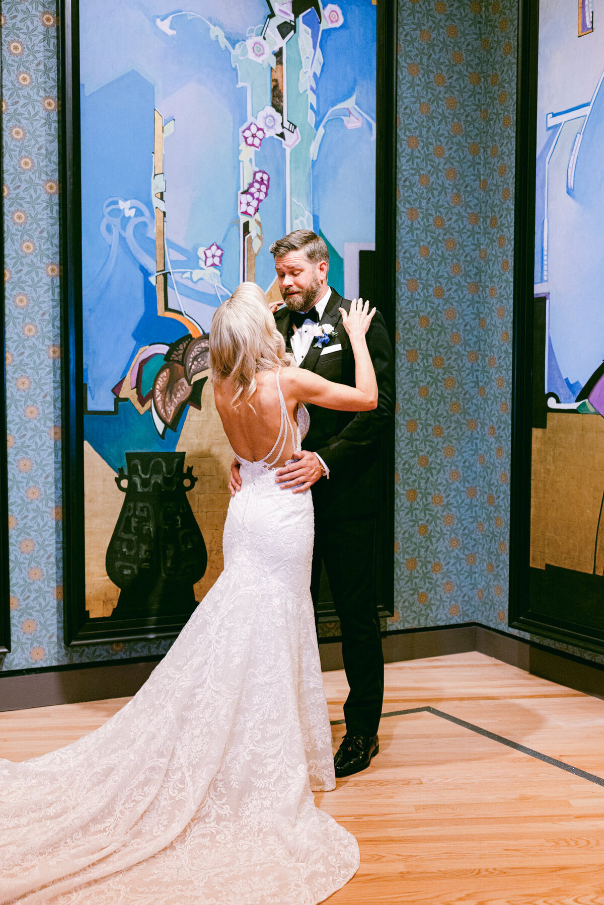 A wedding day photo of the bride & groom during their first look, at Crystal Bridges Museum of American  Art in Arkansas