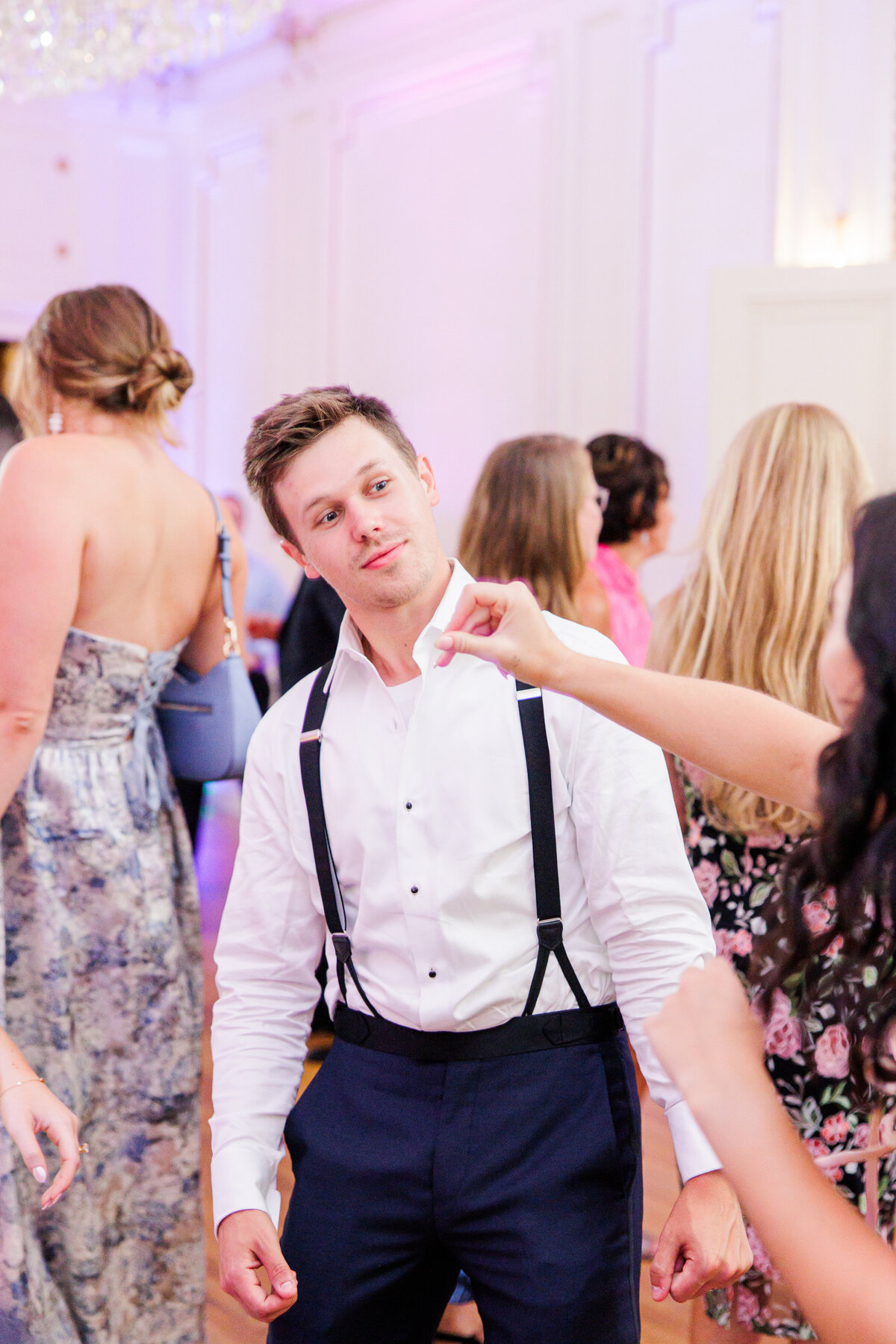 Groom dancing during his wedding reception representing candid and joyful Boston wedding pictures