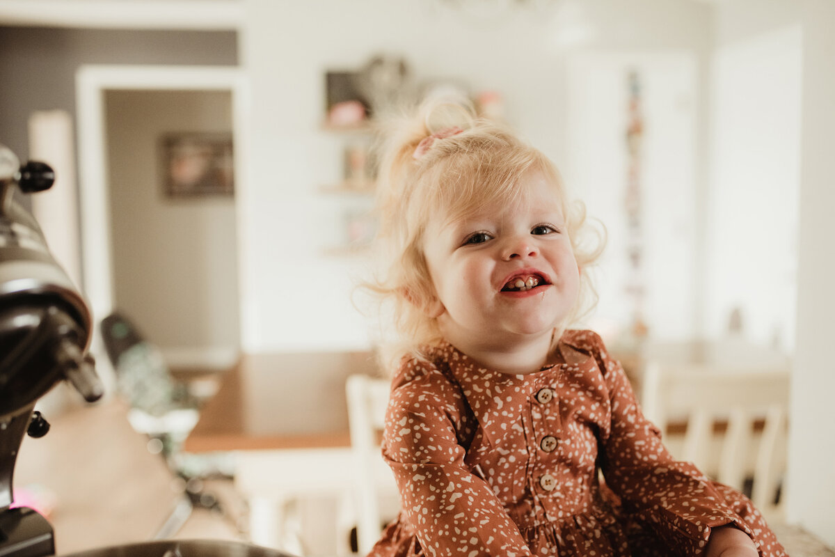 little girl smiling and eating chocolate chips
