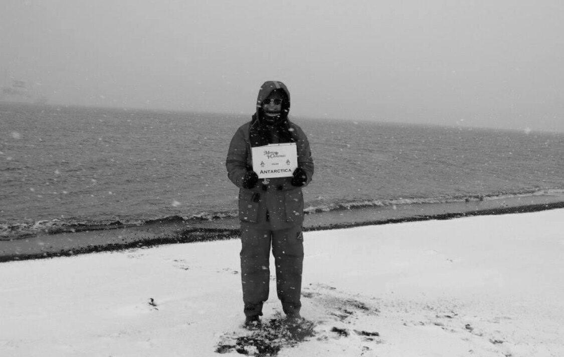 Nicole stands bundled up on icey Antarctica Beach