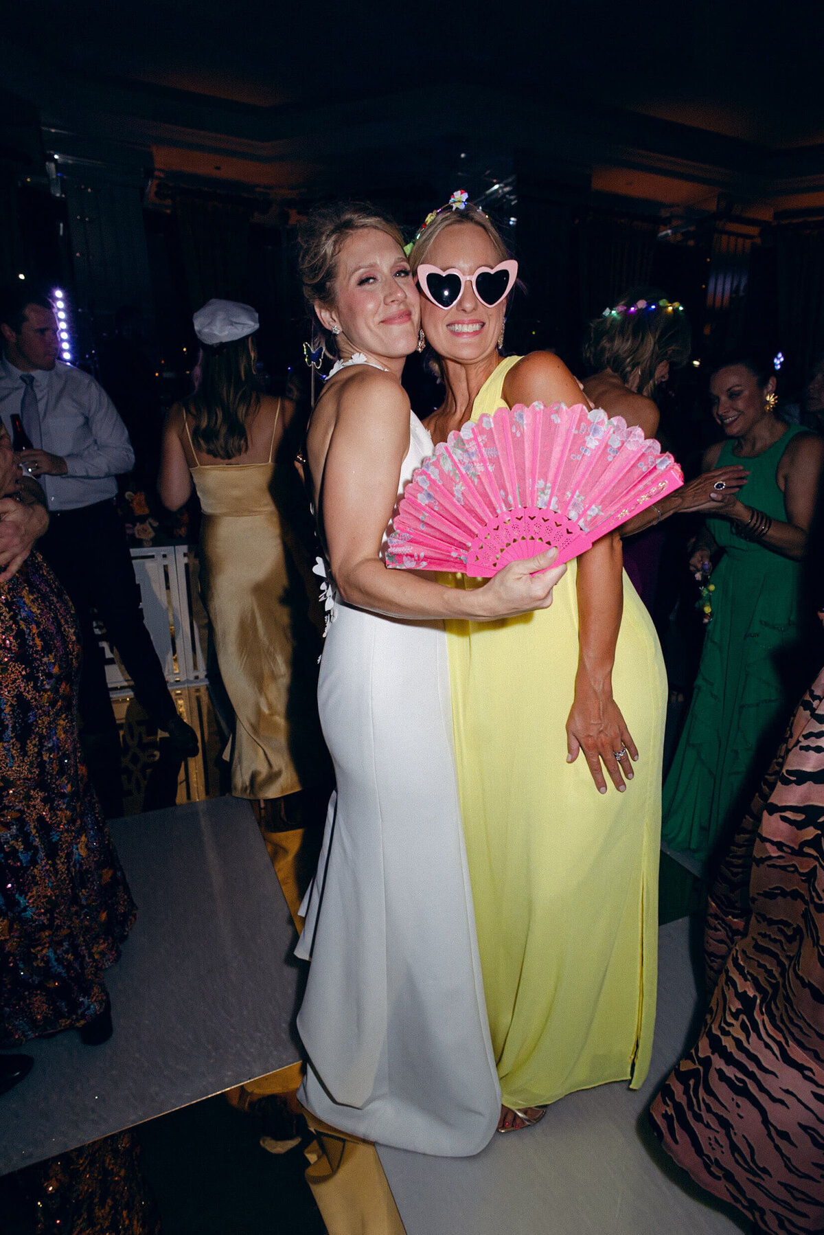 A wedding photo of the bride with one of her bridesmaids during the wedding reception