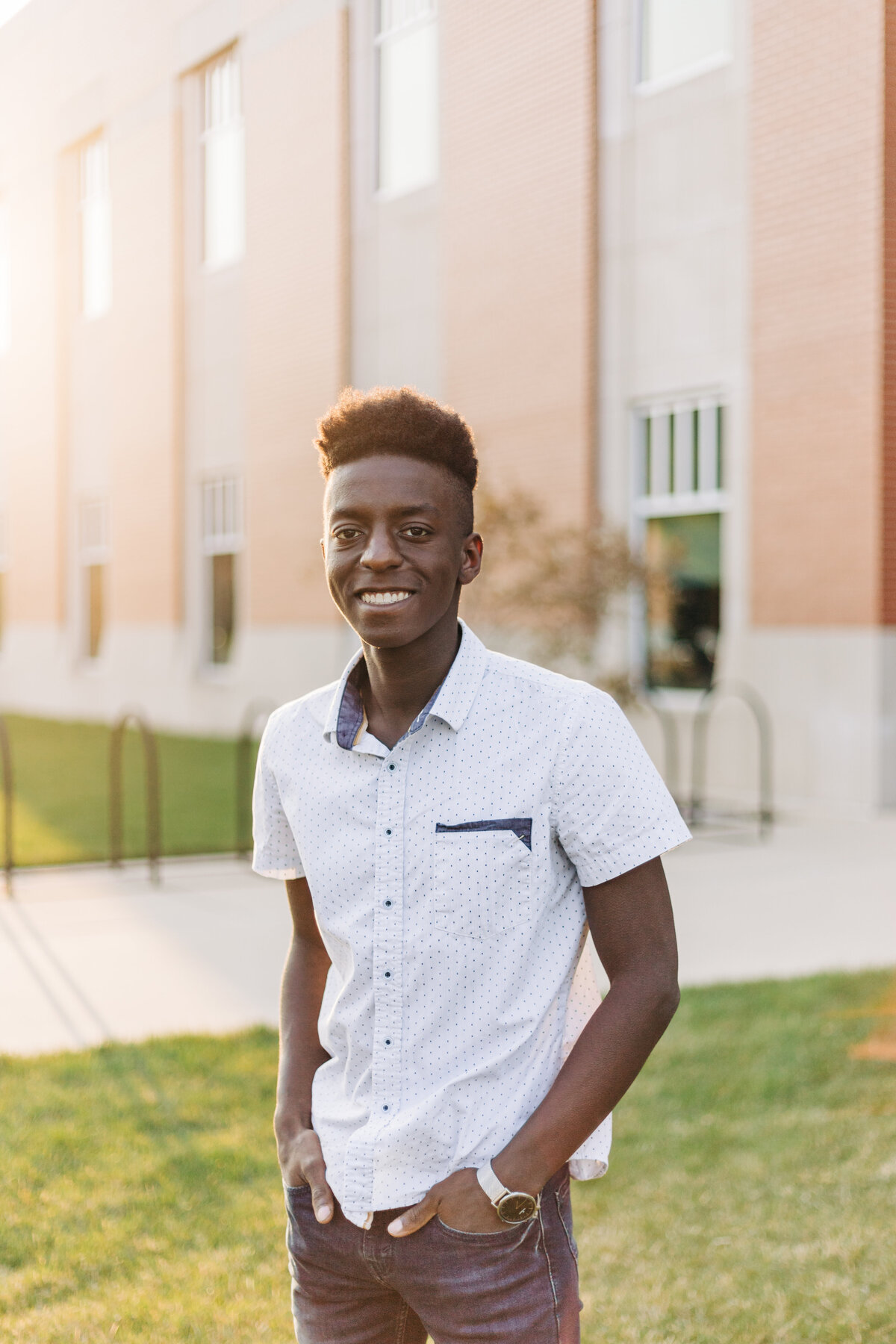 guy smiling with hands in his pockets