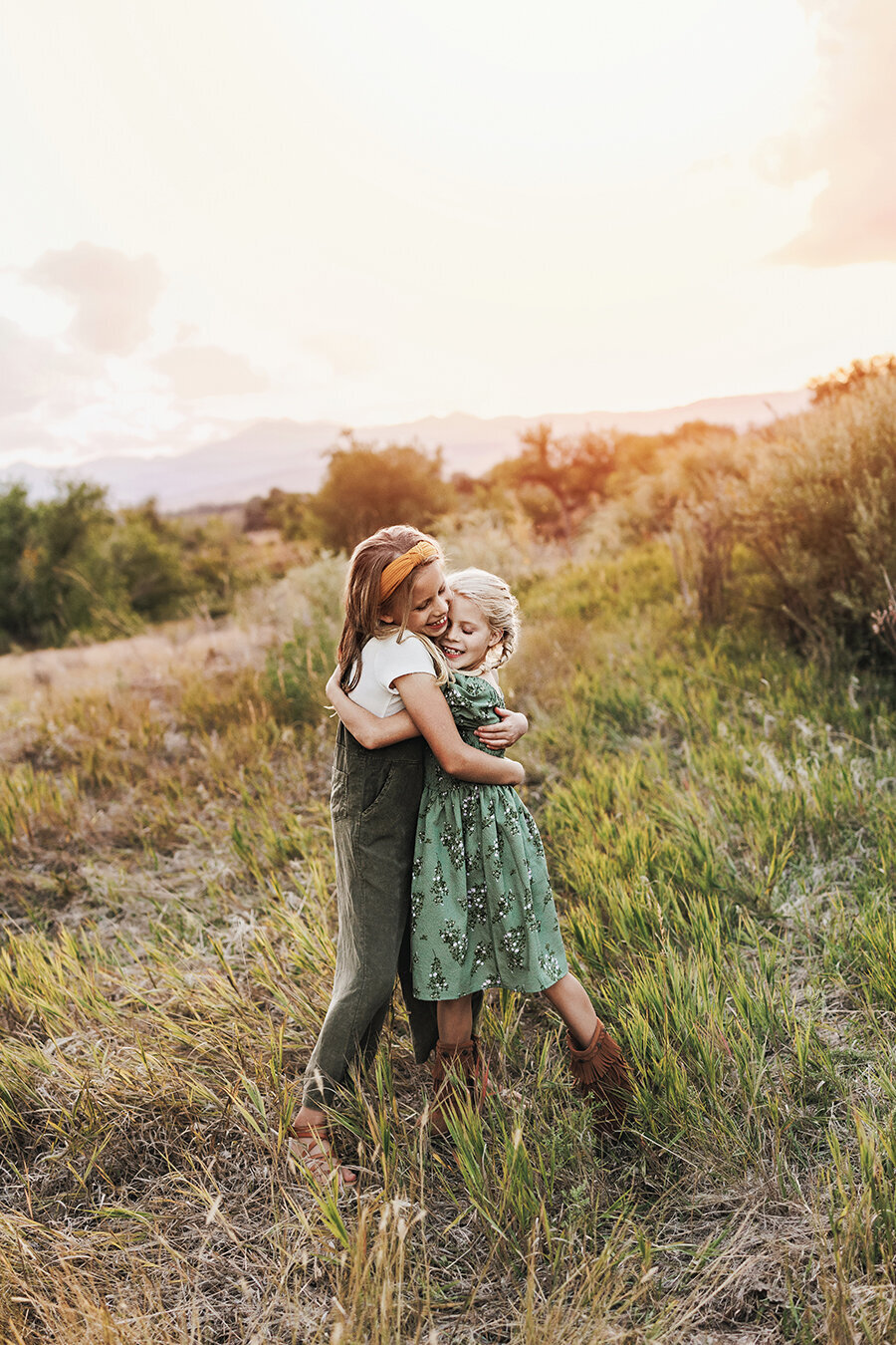 Sisters embracing for family pictures in colorado