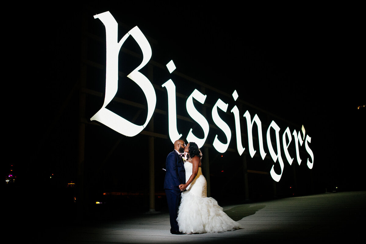Wedding portrait of newlyweds on the rooftop of the Bissinger’s Building, taken during their wedding reception at the Caramel Room.