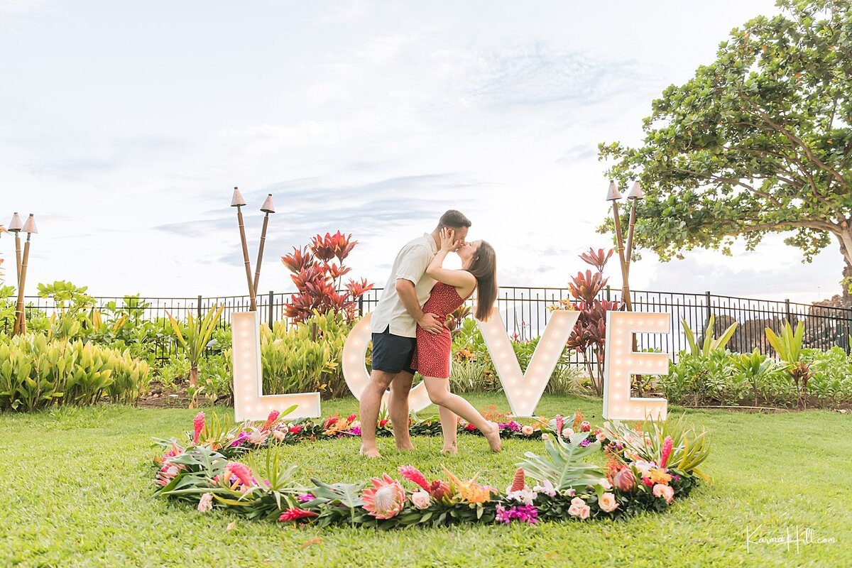 proposal setup with "Love" sign in background