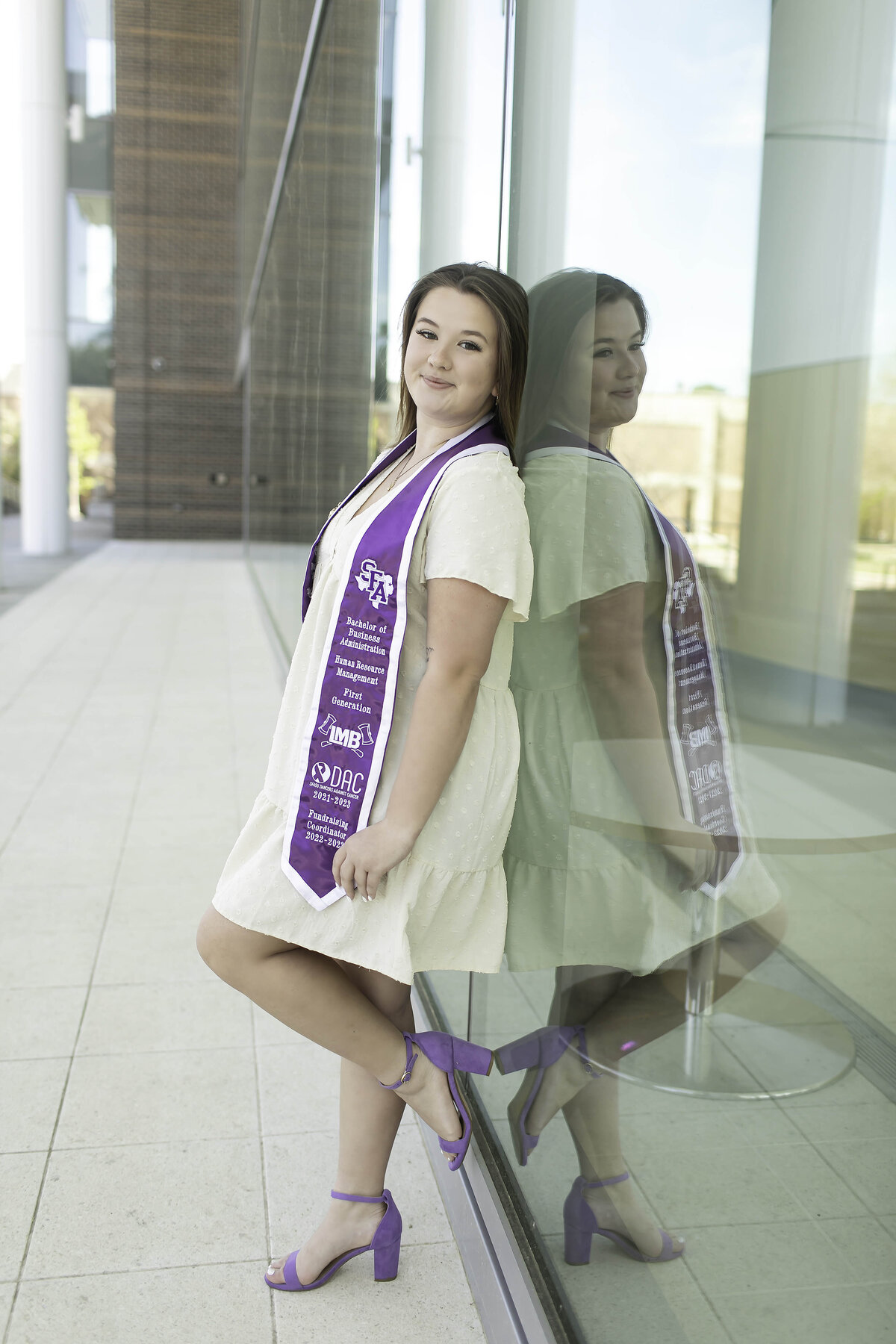  high school senior smiles softly, dressed in their favorite casual outfit