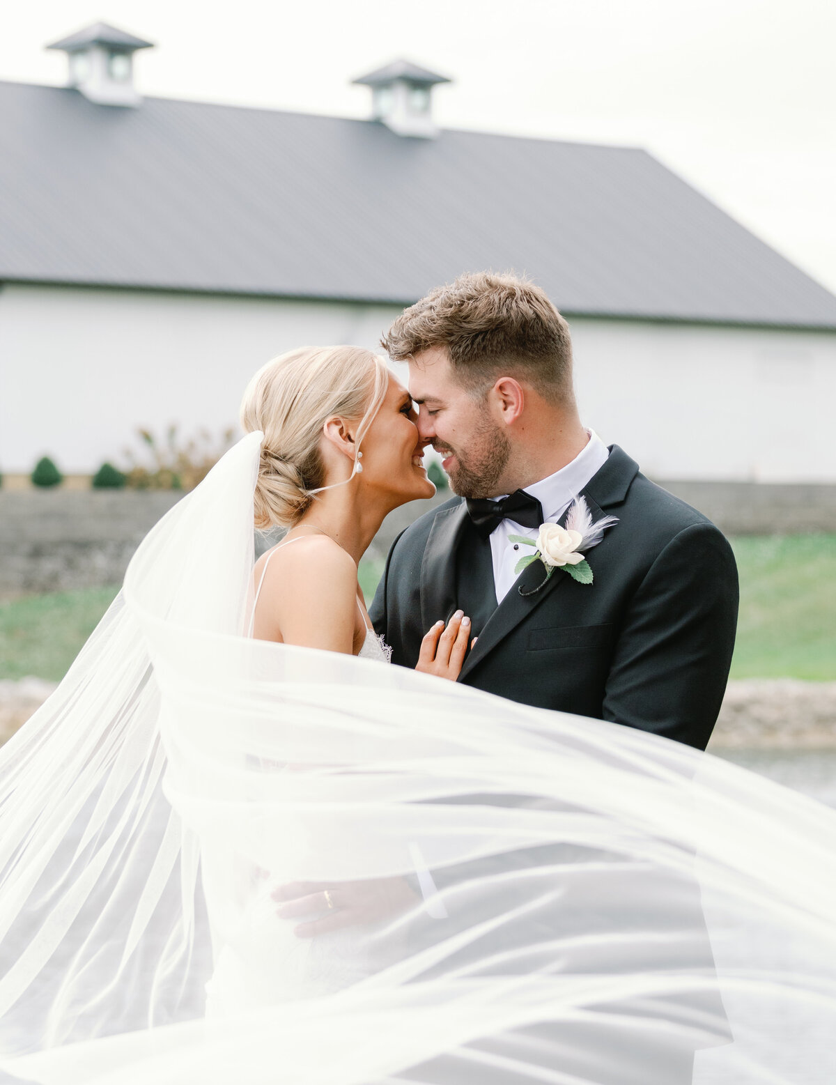 a couple at their destination wedding with a long veil