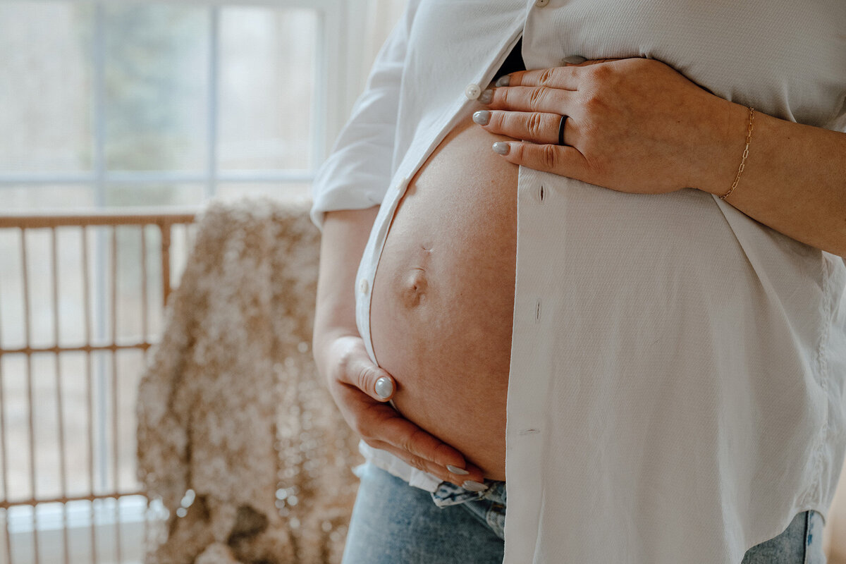 Mother holding her pregnant stomach 