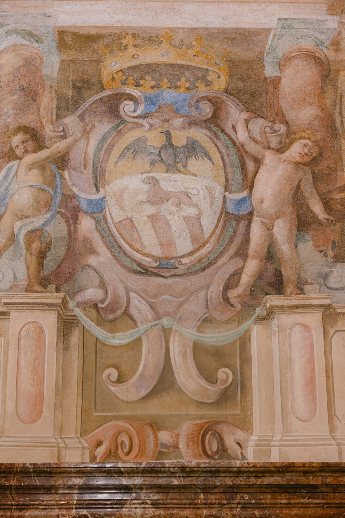 A wedding photo showing the wall art at the wedding venue villa balbiano on Lake Como