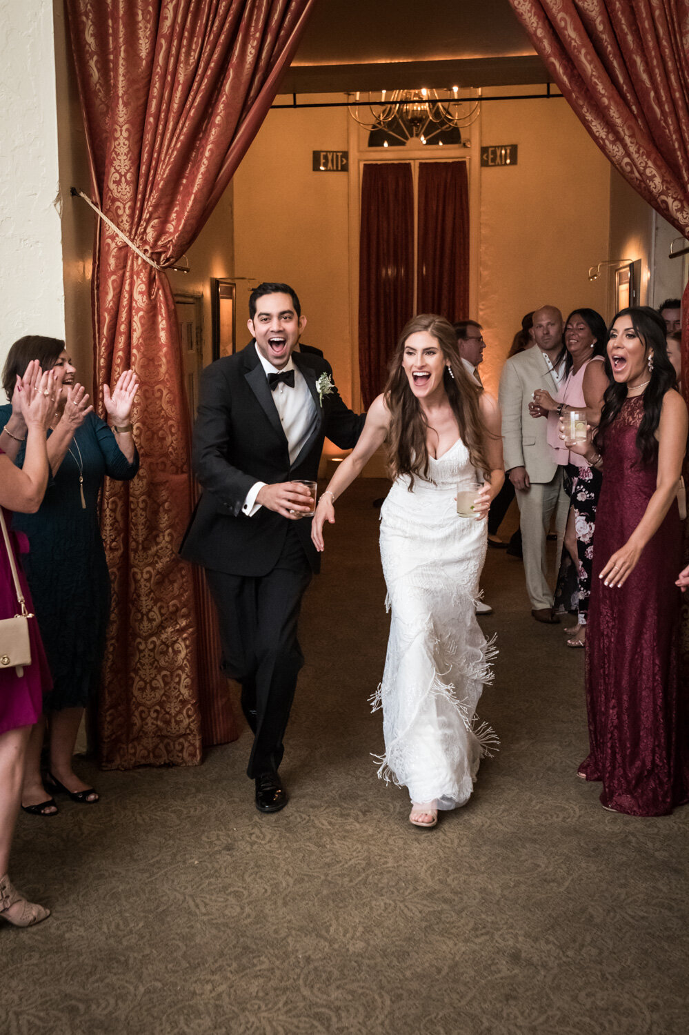 Bride and groom entering reception