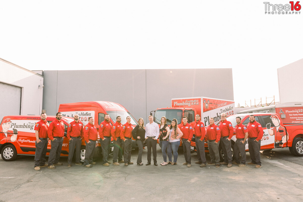 Full team of plumbers gather together for a group corporate photo